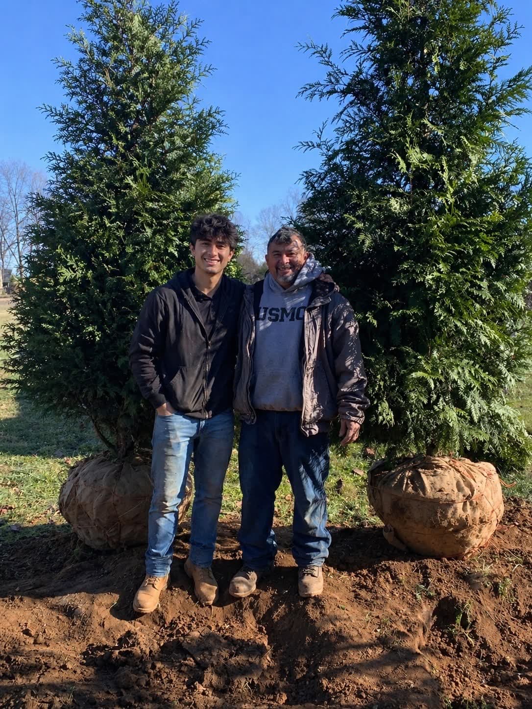 Skylar and a family member working at Orlando's Landscaping in Lexington